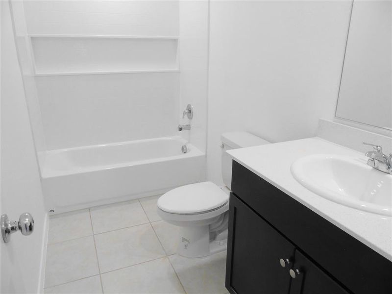 Full bathroom with tile patterned flooring, vanity, toilet, and tub / shower combination