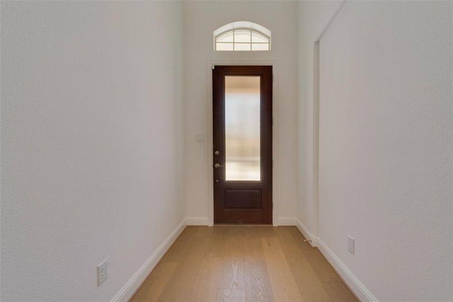 Doorway featuring wood-type flooring