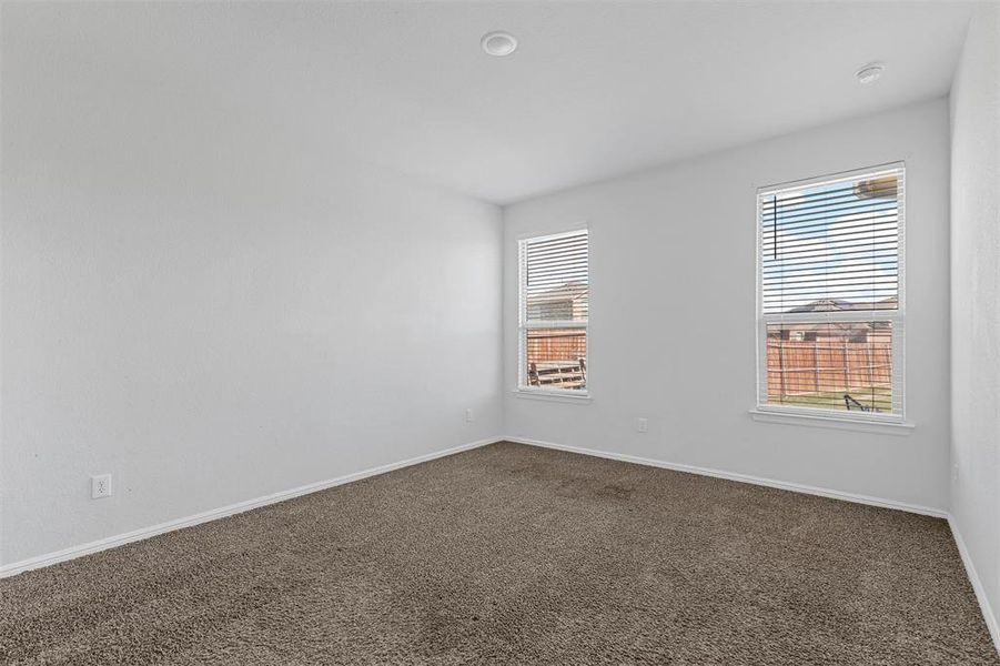 Spare room with dark carpet