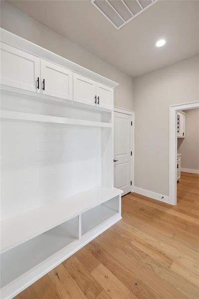 Mudroom with light hardwood / wood-style flooring