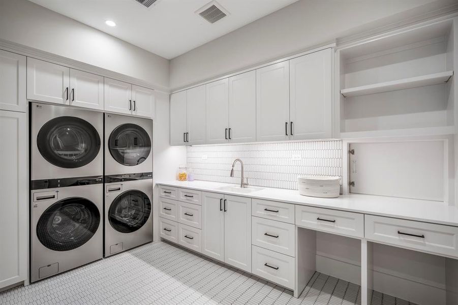 ...the 2nd floor laundry room is designed to be a true workhorse of a room with dual washer and dryers included and a passthrough from the Owner's Wardrobe!