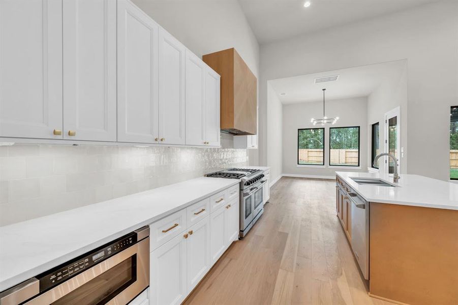 Another view of the kitchen showing the microwave drawer and perimeter cabinets. Note the under cabinet lighting and hidden outlets!