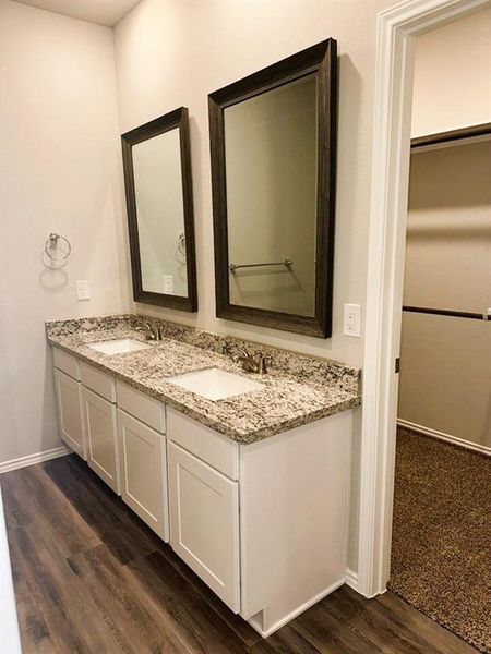 Double sinks, granite counters, framed mirrors- this master bath has it all!