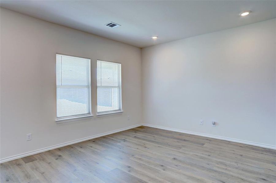 Empty room with light hardwood / wood-style flooring