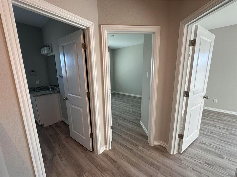 Hallway with hardwood / wood-style floors