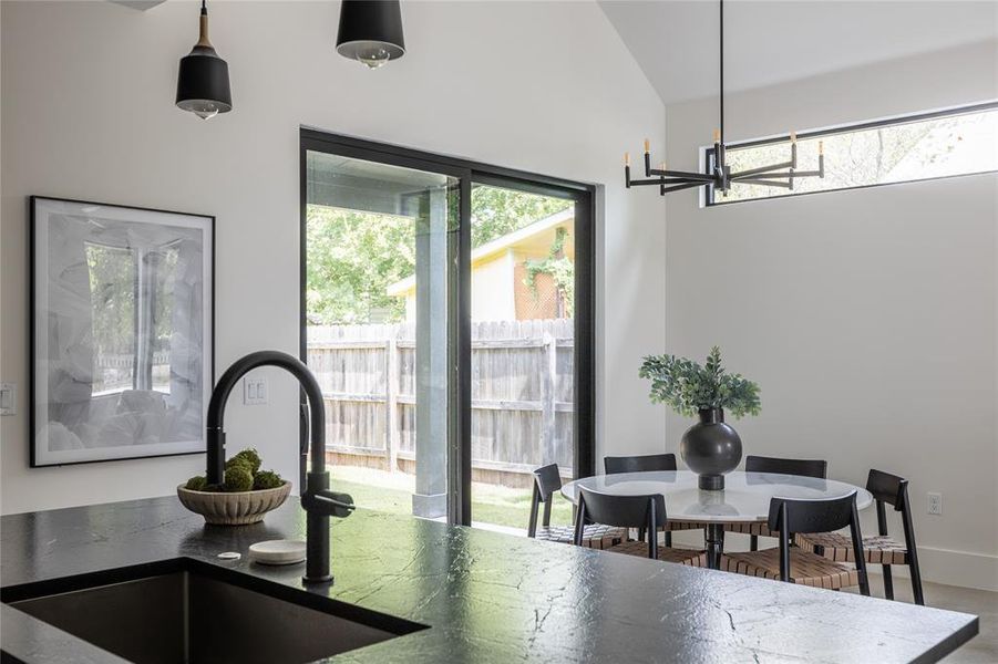 Dining nook with sliding glass doors to one of the multiple outdoor living spaces.