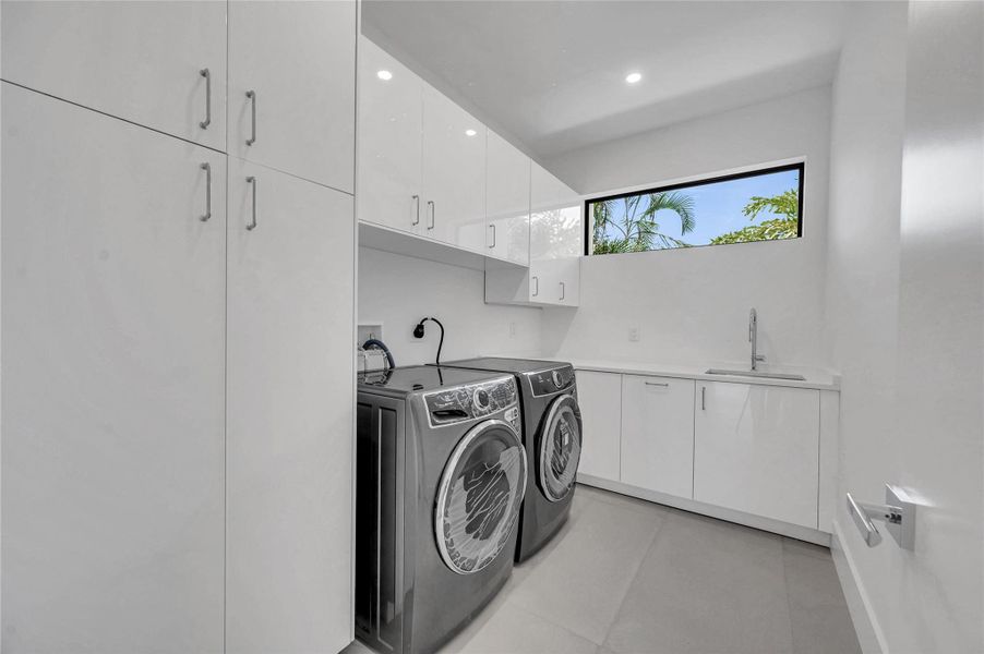 Large laundry room includes a sink
