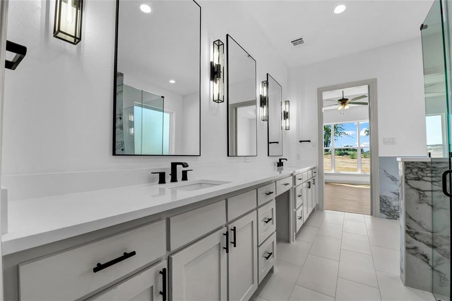 Bathroom featuring tile patterned flooring, ceiling fan, a shower with door, and vanity