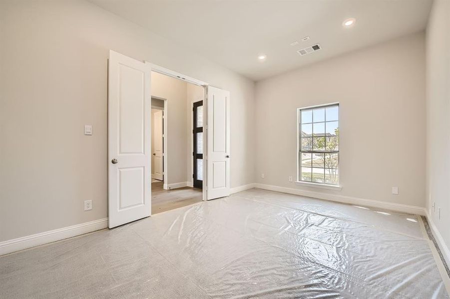 Empty room with light hardwood / wood-style flooring