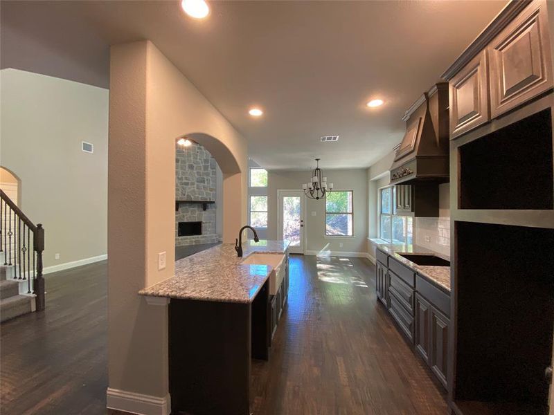 Kitchen with stainless gas cooktop, built-in double ovens with microwave, and dishwasher