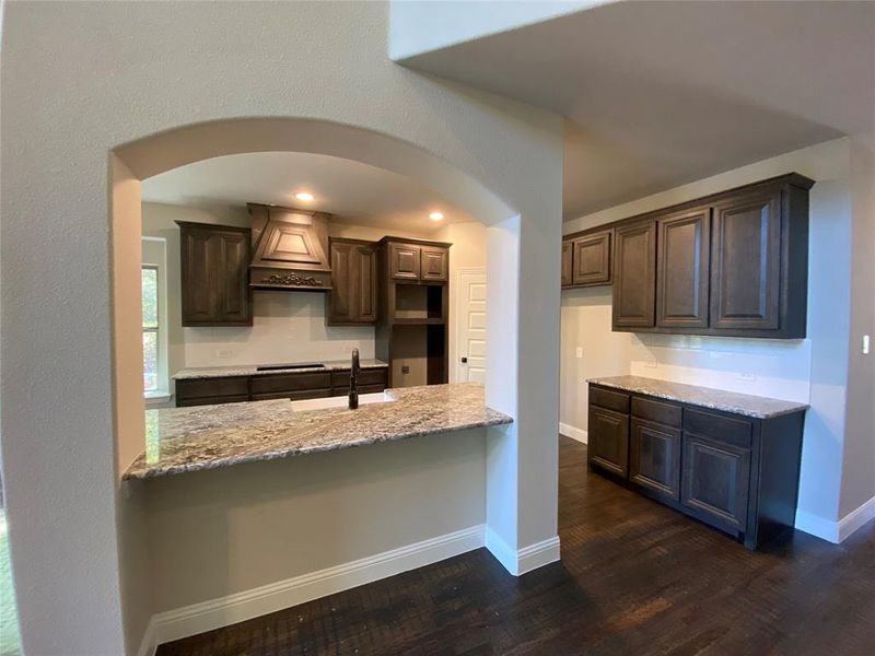 Kitchen with architectural eyebrow arch