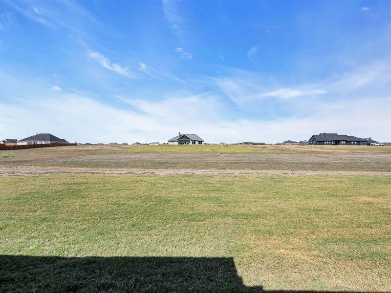 View of yard with a rural view