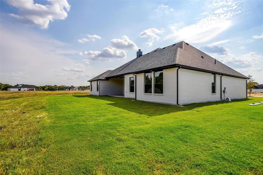 View of side of home with a lawn