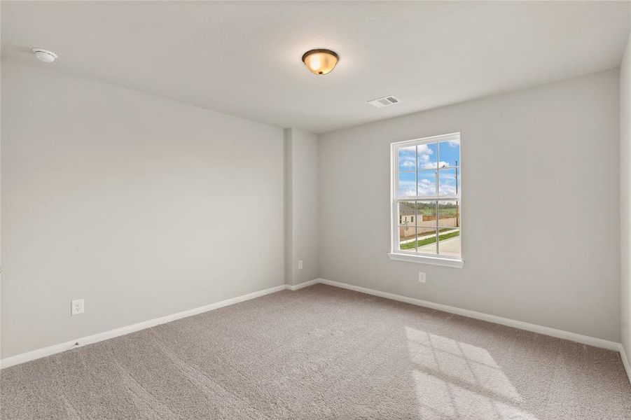 Your secondary bedroom features plush carpet, fresh paint, closet, and a large window that lets in plenty of natural lighting.