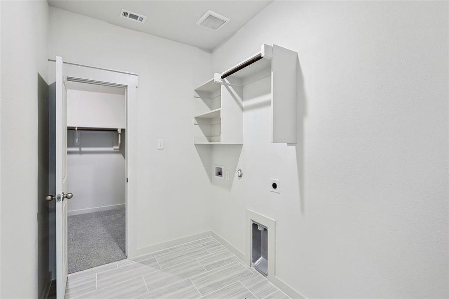 Laundry area featuring light carpet, washer hookup, hookup for a gas dryer, and electric dryer hookup