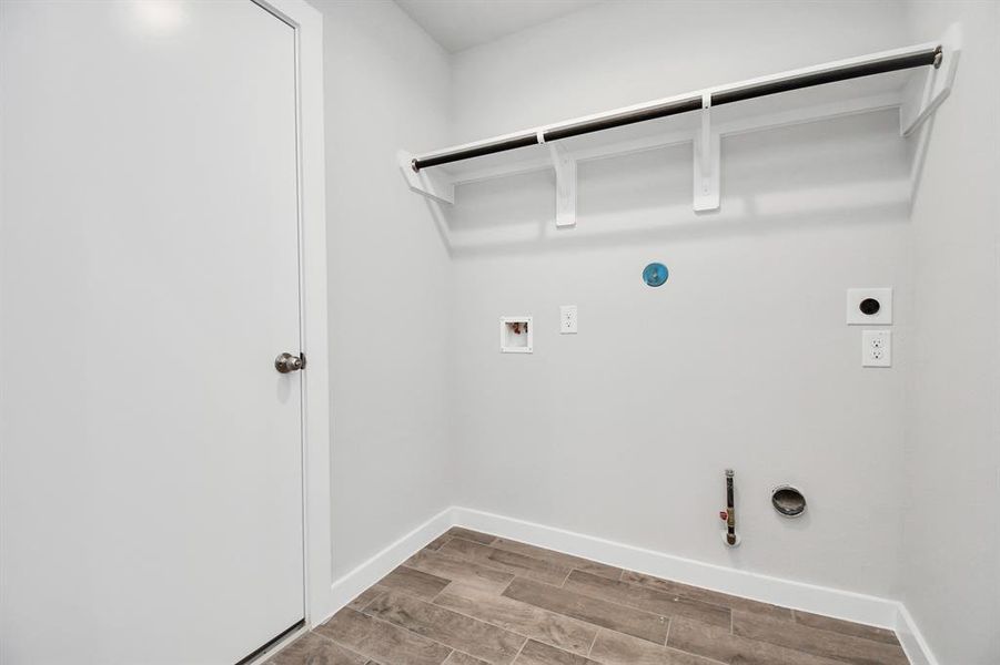 Spacious utility room equipped with both electric and gas dryer connections.