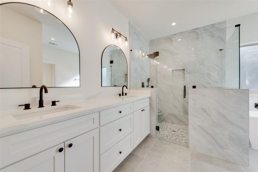 Bathroom featuring vanity, a shower with shower door, toilet, and tile patterned flooring