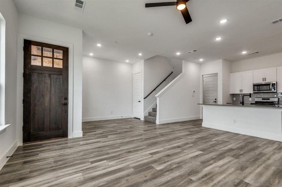 Entrance foyer with light hardwood / wood-style floors, ceiling fan, and sink