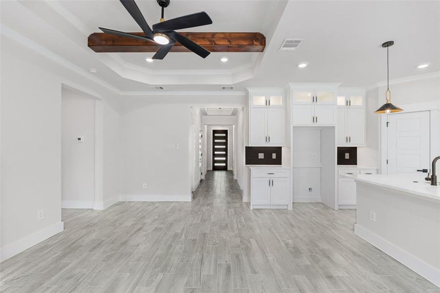 Kitchen featuring light hardwood / wood-style flooring, ceiling fan, and white cabinetry