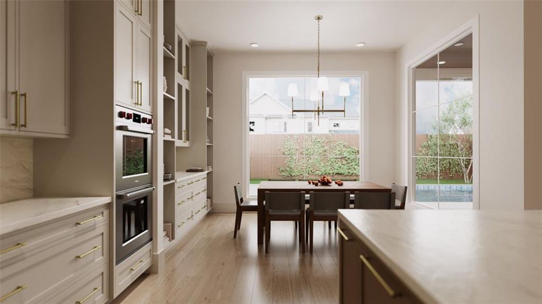 Breakfast Area with Fixed Shelving, Built-In Cabinets with Glass Fronted Doors, Glass Shelves and Lighting. There is also a Slab Quartz Counter with a Slab Quartz Backsplash and Under-Counter Storage Drawers.