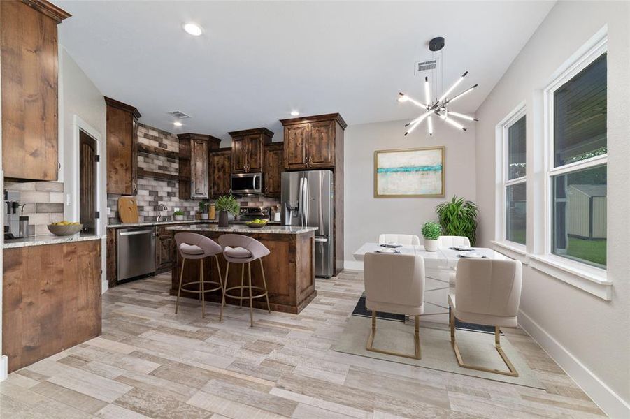 Virtually Staged. Welcome to your culinary haven, where sleek tile flooring spans the spacious kitchen, complemented by large windows that flood the area with abundant natural sunlight, creating a bright and airy atmosphere. This inviting space offers plenty of room to set up a kitchen table, ideal for enjoying casual meals or gathering with family and friends.