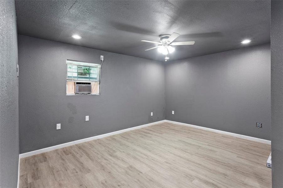 As you enter the garage apartment, you enter into the living area with new laminate flooring for easy cleaning, plus the entire place has new paint and each area has its own AC unit