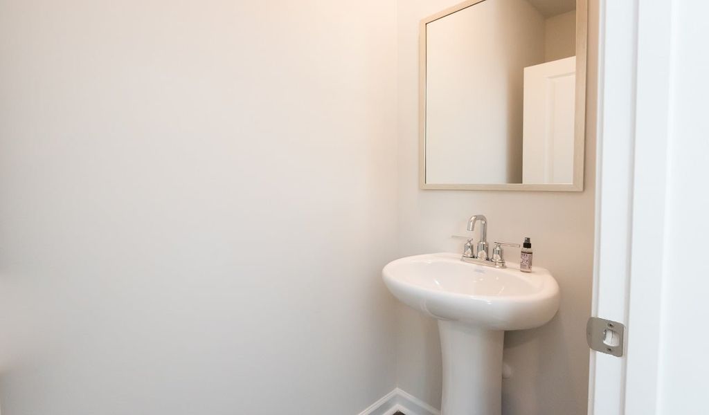 A powder room for guests is located on the main level.