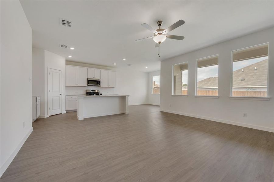 Unfurnished living room featuring light hardwood / wood-style flooring and ceiling fan