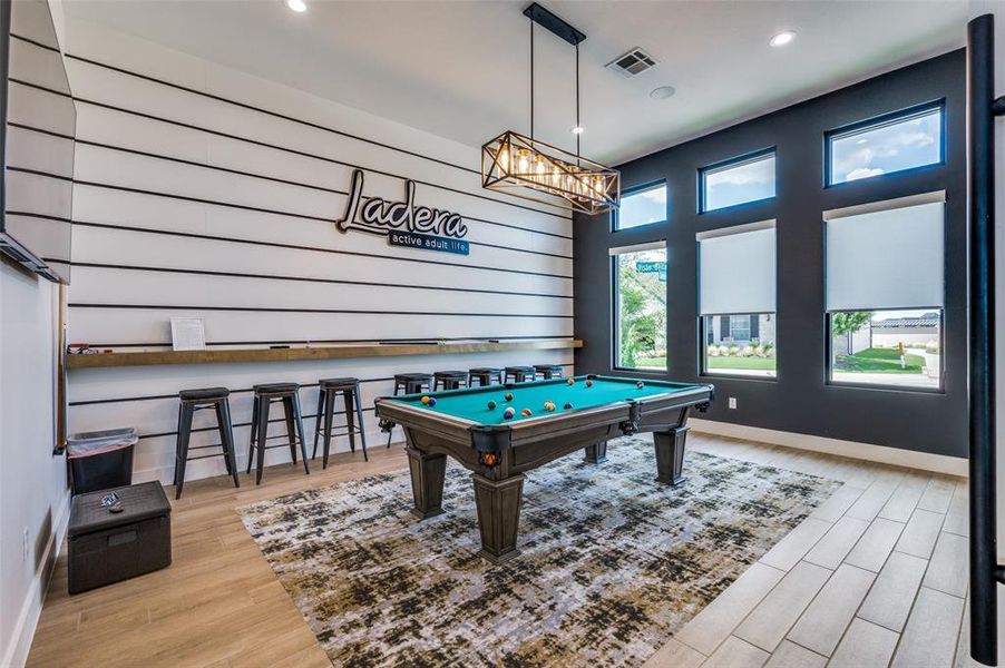 Game room with professional billiard table and light LVP flooring. Join  homeowners in billiard tournaments.