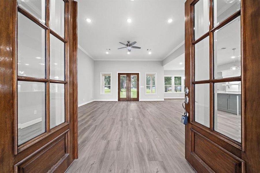 Walking through arched, 8 ft tall Mahogany front doors into the main living area