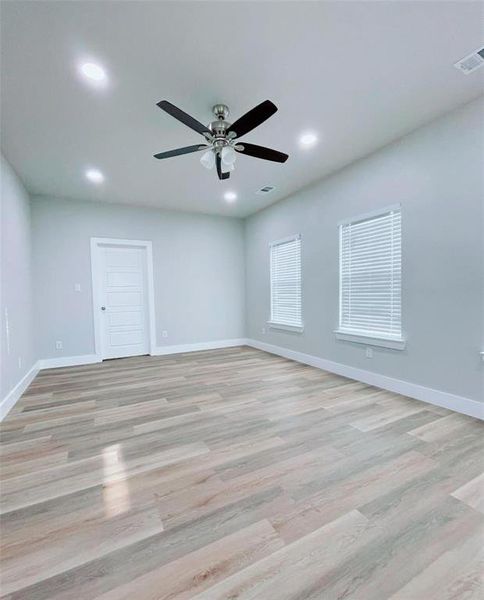 Spare room with light hardwood / wood-style flooring and ceiling fan