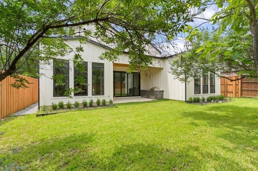 Rear view of property featuring a patio and a lawn