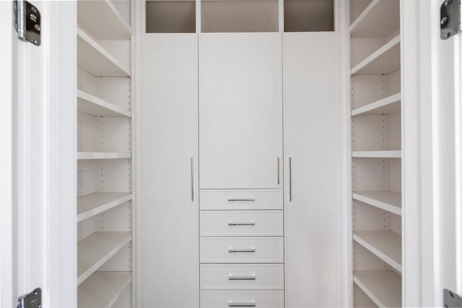 Dual closets provide ample storage space and feature furniture style built-ins and dressers for your organizational needs.