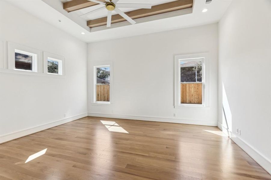 The primary bedroom features white oak beams.