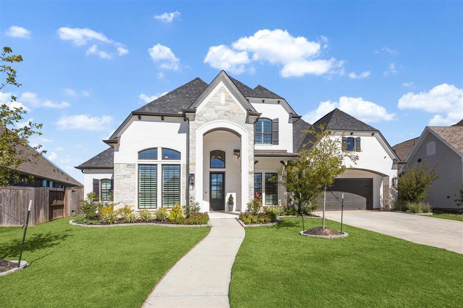 Welcome to this spacious two-story home with a stone and stucco exterior, featuring an arched entryway, and large windows set in the sought after community of Jordan Ranch.