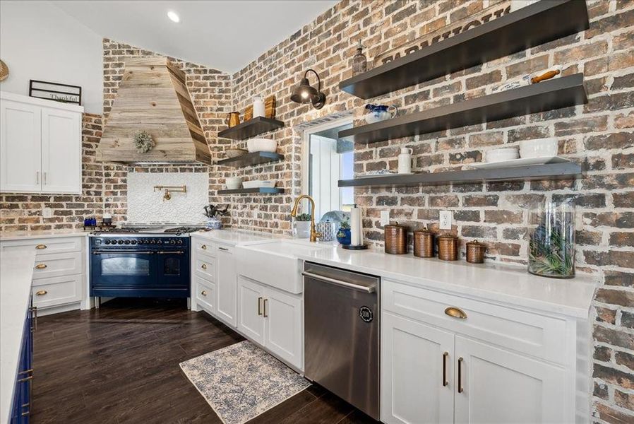 Kitchen featuring stainless steel dishwasher, sink, double oven range, dark hardwood / wood-style floors, and white cabinetry