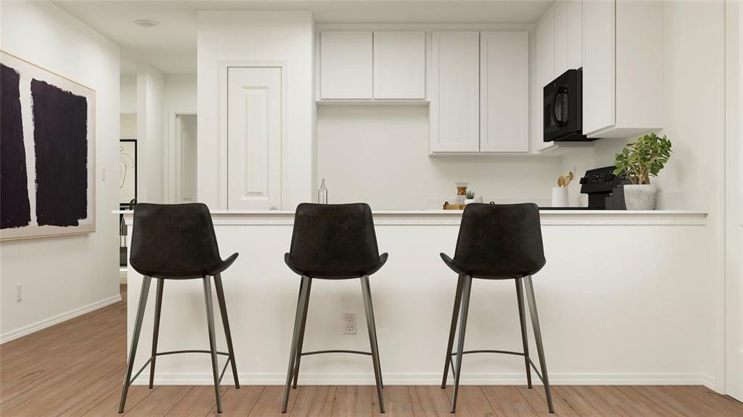 Kitchen featuring white cabinets and light hardwood / wood-style flooring