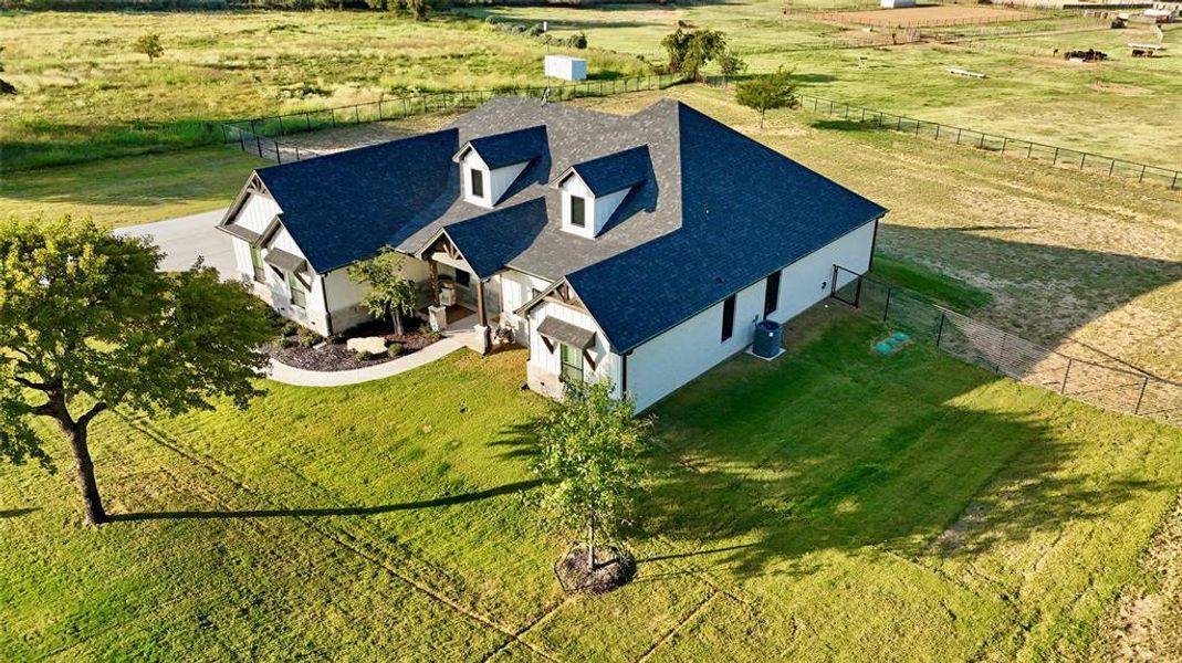 Birds eye view of property with a rural view