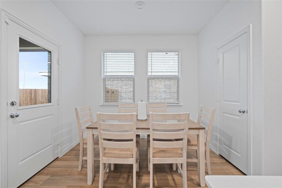 Dining area with light hardwood / wood-style flooring