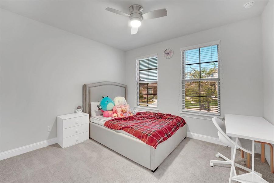 Carpeted bedroom with ceiling fan