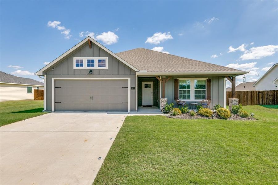 View of front facade with a front lawn and a garage