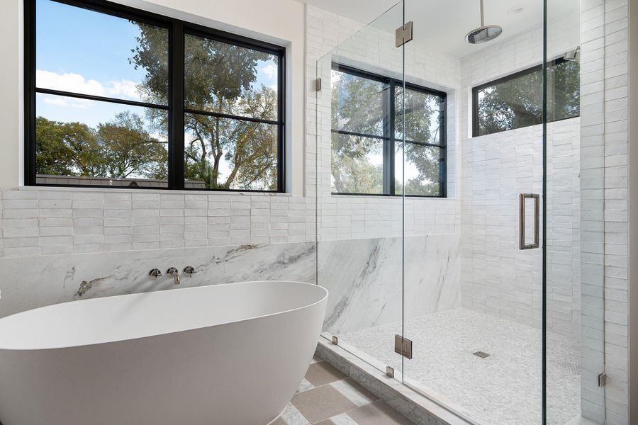 The primary bathroom is complete with a soaking tub and a walk-in shower.