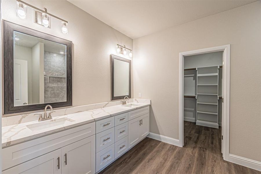 Bathroom featuring hardwood / wood-style flooring and double sink vanity