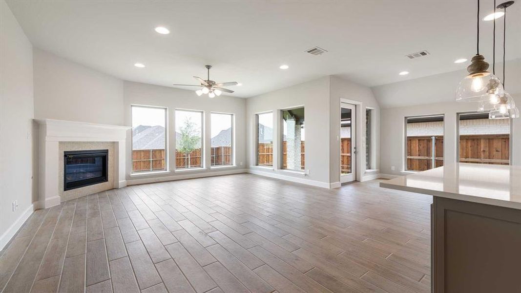 Unfurnished living room with wood-type flooring and ceiling fan