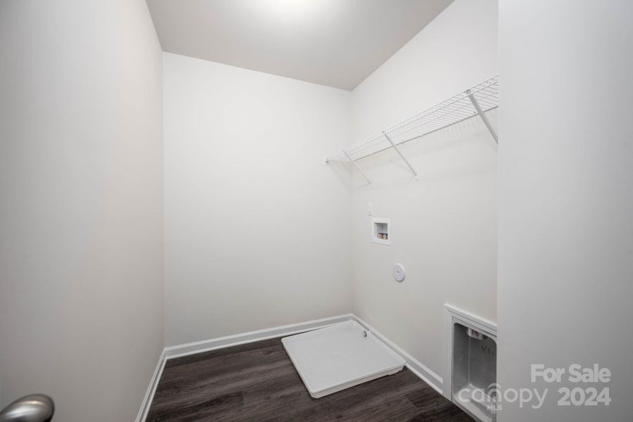 Laundry room on upper level with shelving