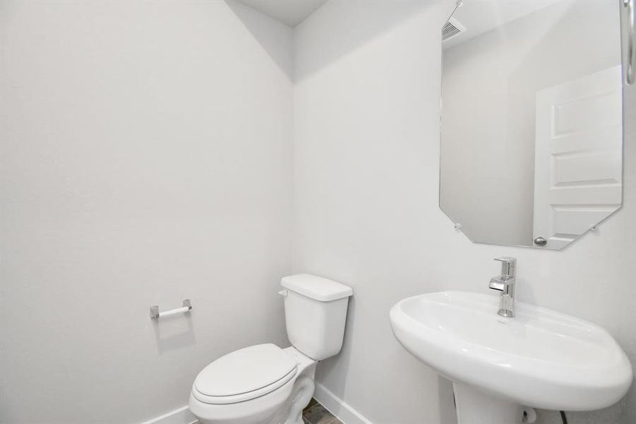 Spacious half bath located on 1st floor.