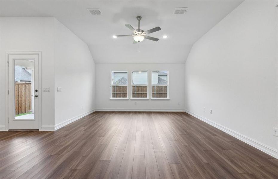 Sunbathed gathering room with large windows *real home pictured