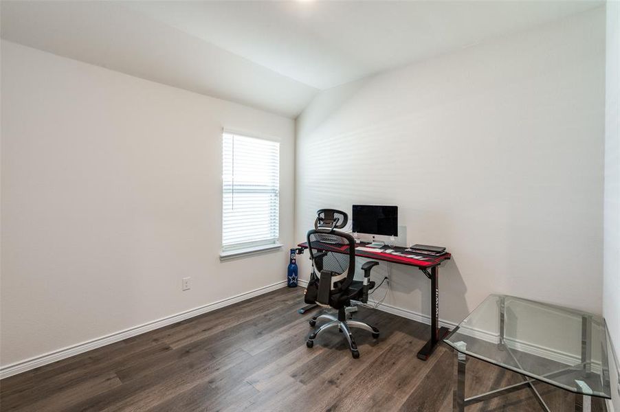 Office area featuring lofted ceiling and dark wood-type flooring