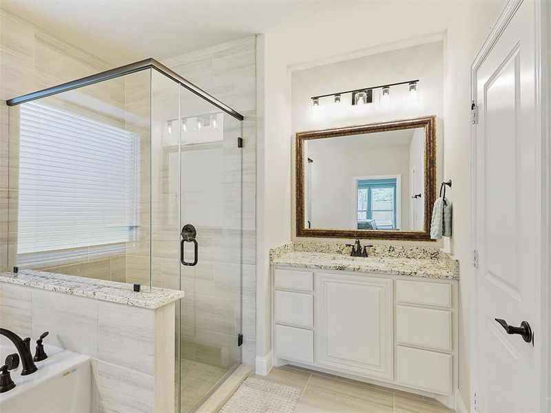 Primary Bathroom with vanity, separate shower and tub, and tile patterned floors