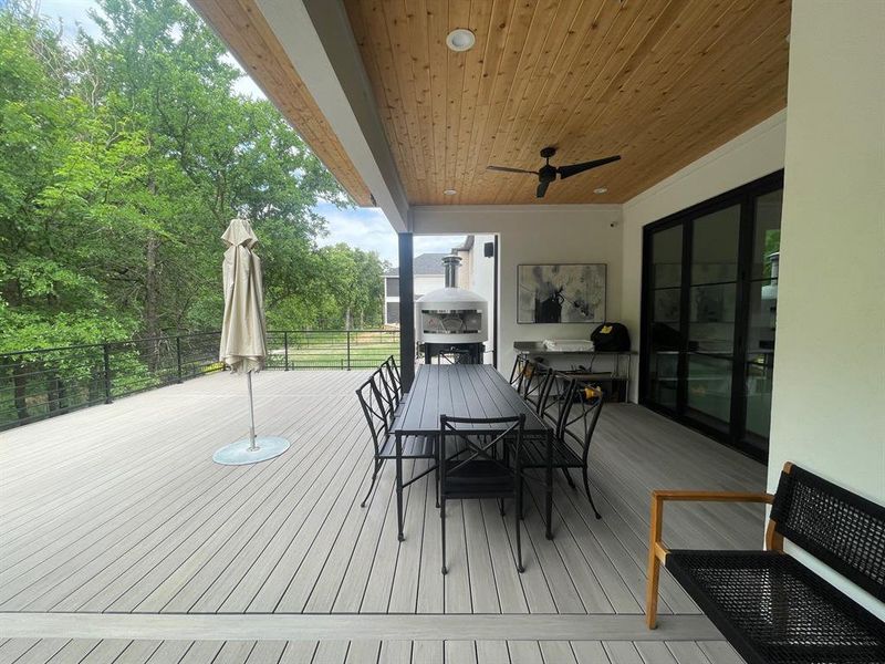 Wooden terrace featuring ceiling fan